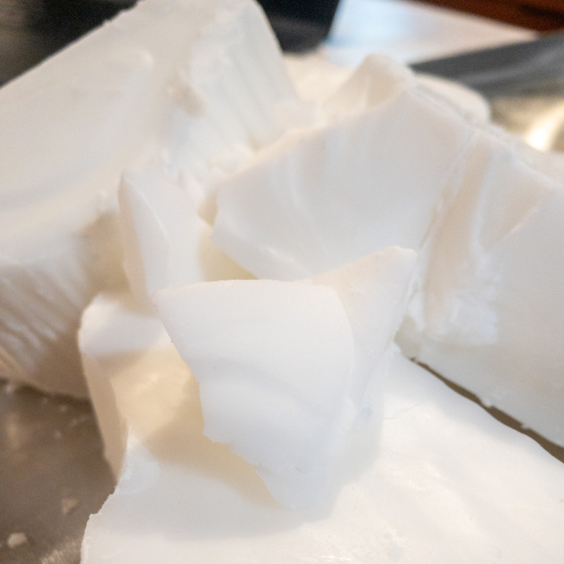 square image of blocks of pure white coconut wax before its melted down into a candle